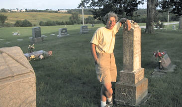 Maria standing beside her family plot in Woodlawn Cemetary