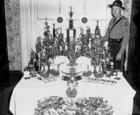 Scoop Standing Proudly With His Many Awards and Medals